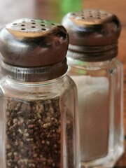 Pepper and salt on a table in a street cafe.