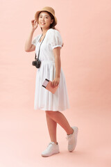 Travel and Lifestyle concept: Full length studio portrait of pretty young student woman holding passport with tickets