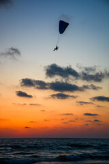 Paraglider in silhouette above the Mediterranean Sea near Haifa Israel

