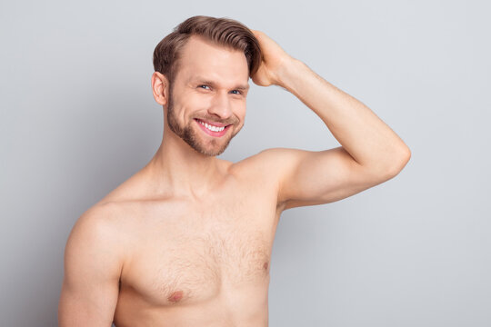 Photo of cheerful blond hairdo guy touch hair without clothes isolated on grey color background