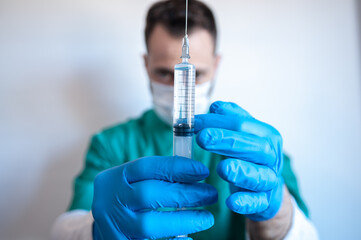 Nurse or doctor holds a covid-19 vaccine in his hands