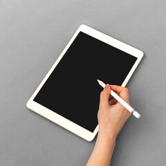 Woman hand with stylus pencil for tablet, mockup with blank screen, business and office table...