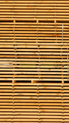 Storage of piles of wooden boards on the sawmill. Boards are stacked in a carpentry shop. Sawing drying and marketing of wood. Pine lumber for furniture production, construction. Lumber Industry.