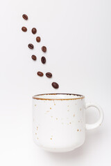 Ceramic mug and coffee beans on white background. Coffee break concept. Top view. Copy space