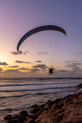 Paraglider in silhouette above the Mediterranean Sea near Haifa Israel
