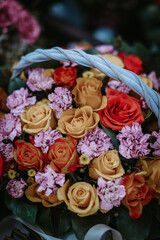 Bouquet of red and orange roses in a basket