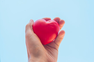 Red heart in woman hands, heart health and peace concept.World heart health day.World organ donation day.Healthy heart concept for healthy life.Selective focus.