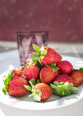 Wild and organic strawberries. Dishes with fresh strawberries. Fruit photography