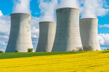 Nuclear power station. Cooling towers of a nuclear power plant in beautiful summer landscape....