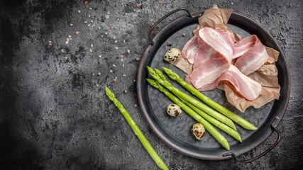 Keto food. Fresh Asparagus with raw bacon. Detox and healthy concept. banner, menu recipe place for...