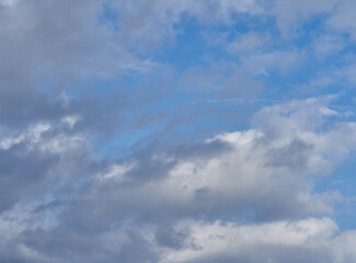 Naklejka na ściany i meble Dramatic thunderclouds float across the blue sky