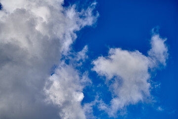 Dramatic thunderclouds float across the blue sky