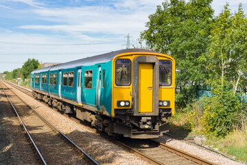 Fototapeta na wymiar Generic diesel multiple unit or DMU train on a British railway commonly used on rural and main rail lines for commuter services in the UK