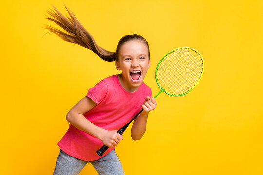 Photo of purposeful cute small schoolgirl dressed pink t-shirt screaming shouting playing tennis isolated yellow color background
