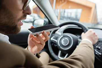 partial view of bearded man recording voice message smartphone while driving car - obrazy, fototapety, plakaty