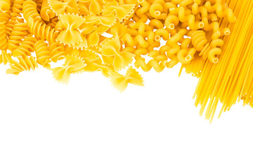 Fototapeta premium Variety of types and shapes of Italian pasta on white background. Top view with copy space