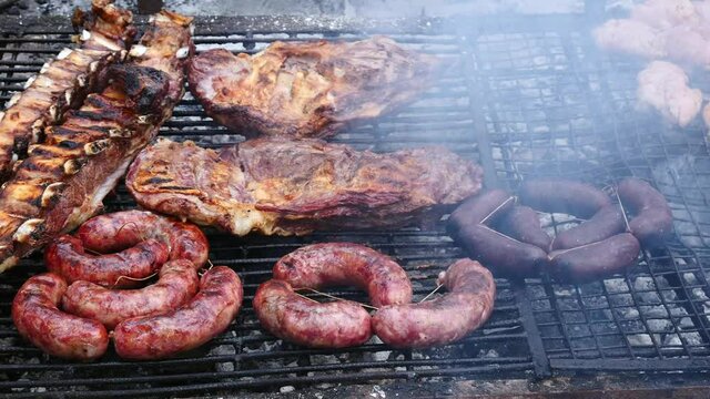 Parrilla, Smoky grill with pieces of a traditional Argentinian barbecue or asado