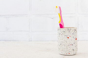 Can with toothbrushes on a white background.