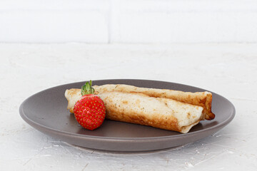 Homemade pancakes filled with cottage cheese on a plate