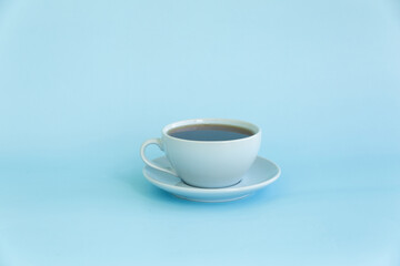 The blue cup and saucer on blue background