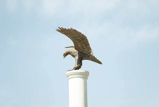 Eagle stone statue on blue sky