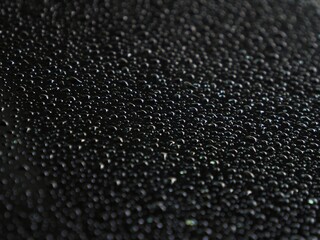 Background picture of rain drops on a black background.