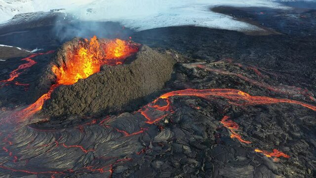 4K Drone aerial video of Iceland Volcanic eruption 2021. The volcano Fagradalsfjall is located in the valley Geldingadalir close to Grindavik and Reykjavik. Hot lava and magma coming out of the crater