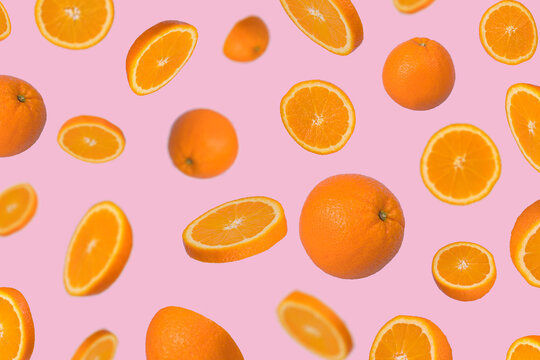Minimal idea with fresh orange sliced on light pink background.