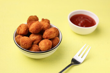 Crunchy chicken popcorn balls chicken nuggets bites for fast food meals with ketchup tomato sauce , fried snack appetizer lean meat balls kids favorite snack