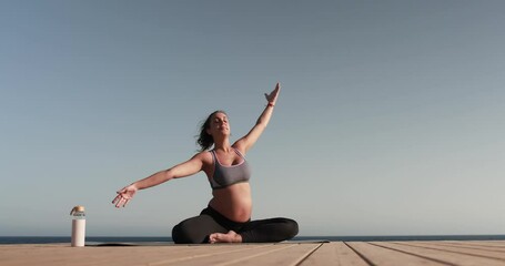 Young pregnant woman doing yoga outdoor - Meditation and maternity concept for an healthy lifestyle - Powered by Adobe