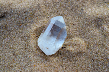 crystal quartz on sand background