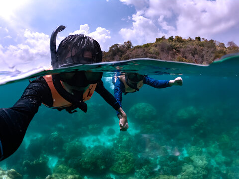 Happiness couple taking selfie under tropical sea by water camera while excursion - Image
