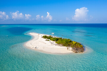 Aerial view of travelers on a small sandy island in the Indian Ocean