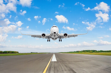 Fototapeta na wymiar Airplane take off in runway against the background of clouds and blue sky.