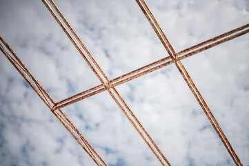 Abstract industrial background blue sky and rod metal reinforcement frame