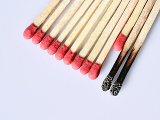 Fresh match sticks rescued from being burnt by the sacrifice of a fresh stick. Concept of social distancing during Covid 19 pandemic.