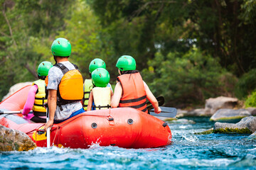 Group of family are rafting on the river turbulent flow. Extreme and enjoyment sport. - obrazy, fototapety, plakaty
