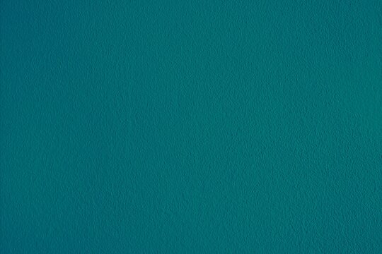 Blue green textured background surface.  Horizontal dark teal backdrop.  Plain cyan blank template, plain wallpaper, copy space.