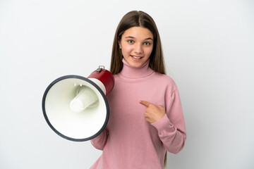 Little girl over isolated white background holding a megaphone and with surprise facial expression