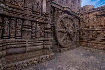 Fototapeta na wymiar Intricate carvings on a stone wheel in the ancient 13th Century AD Sun Temple at Konark, Orissa, India.