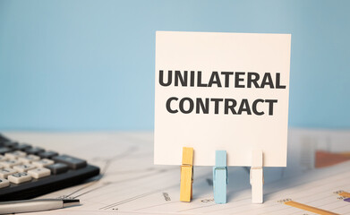 UNILATERAL CONTRACT text near financial reports and calculator.Financial and business concept.