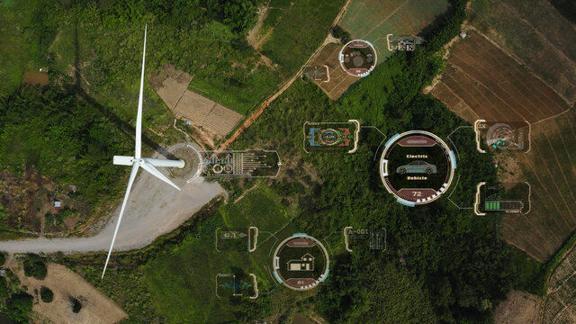 Aerial top view, windmills with digitally generated holographic display tech data visualization. Wind power turbines generating clean renewable energy for sustainable development in green ecologic way