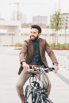 Young contemporary businessman cycling smiling eco friendly