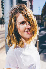 Portrait of young beautiful caucasian blonde hair woman outdoor in the city looking in camera...
