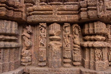 Ancient sandstone carvings on the walls of the ancient Indian temple of 13th century Konark.