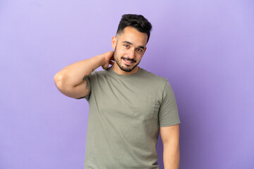 Young caucasian man isolated on purple background laughing