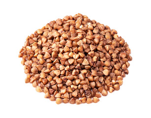 pile of roasted buckwheat grains closeup on white