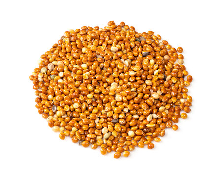 pile of proso millet grains closeup on white