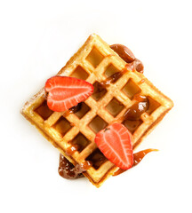 Viennese waffle with caramel syrup and strawberries isolated on white background.