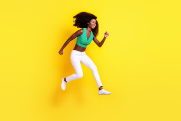 Fototapeta na wymiar Full length body size photo woman jumping high running fast on sale isolated vibrant yellow color background